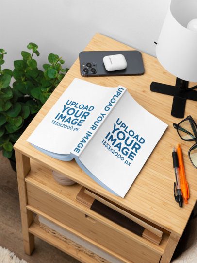 Mockup of an Open Book Placed on a Wooden Nightstand