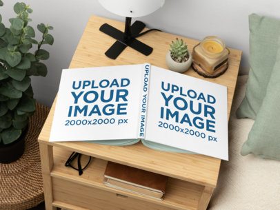 Mockup of a Squared Hardcover Book Placed on a Wooden Nightstand
