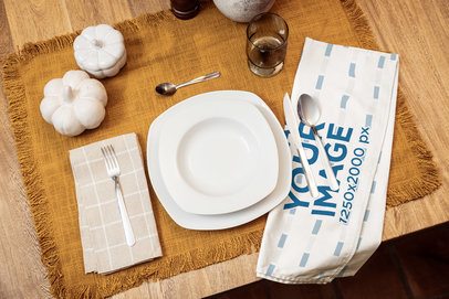 Mockup of a Kitchen Towel Placed on a Table Setting With a Fall Aesthetic