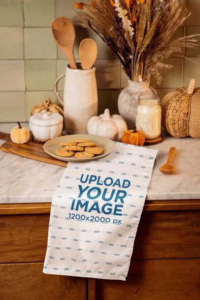 Autumn-Inspired Mockup of a Kitchen Towel Placed on a Counter With Some Cookies