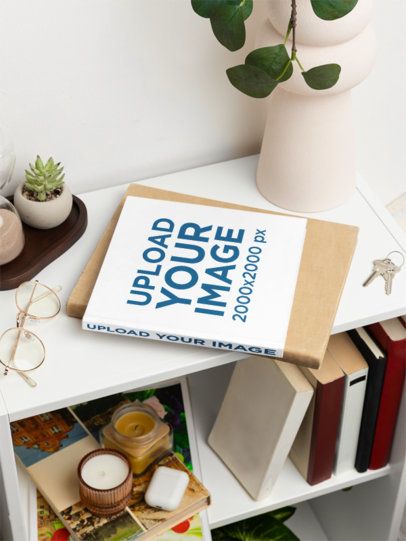 Mockup of a Squared Book Placed on the Top of a Bookshelf