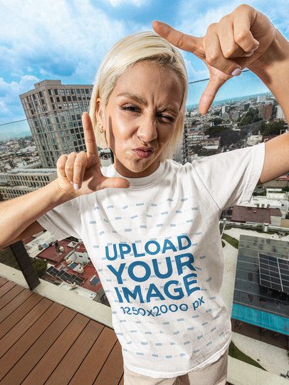 Comfort Colors 1717 T-Shirt Mockup Featuring a Woman Doing a Frame Pose on a Balcony