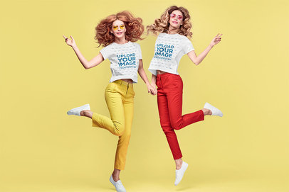 T-Shirt Mockup Featuring Two Women with Colorful Pants Jumping