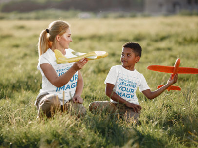 T-Shirt Mockup of a Kid and a Woman Playing With Airplane Toys 