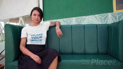 T-Shirt Video of a Tattooed Woman Sitting on a Couch