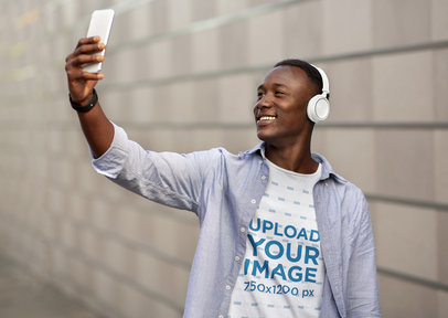 Crewneck Tee Mockup of a Man with Headphones Taking a Selfie