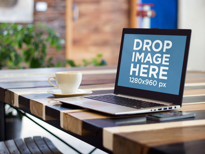 Mockup of a Laptop on Wooden Striped Table