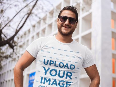 Smiling Dude Wearing a Tshirt Mockup and Sunglasses While in the City