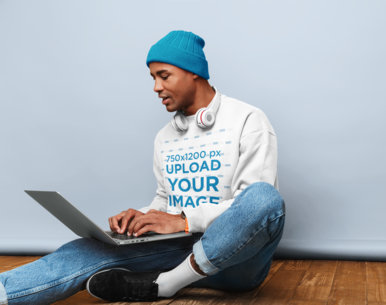 Sweatshirt Mockup of a Hipster Man Working on His Laptop