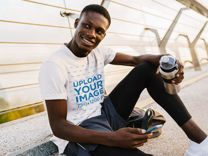 T-Shirt Mockup Featuring a Man Chilling in an Urban Setting