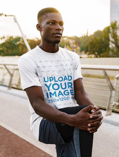 T-Shirt Mockup of a Young Man Stretching Before a Run