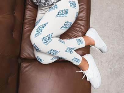 Girl Legs Wearing Leggings Mockup and White Shoes on a Brown Sofa a15706