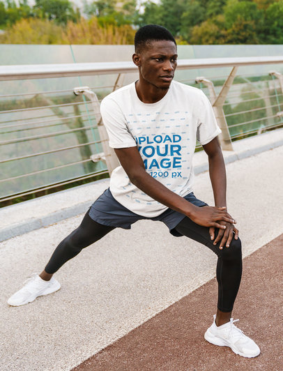 T-Shirt Mockup of a Man Warming Up for a Jog