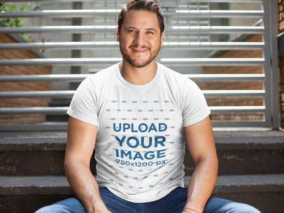 Middle Aged White Man Wearing a T-Shirt Mockup While Sitting Down Indoors