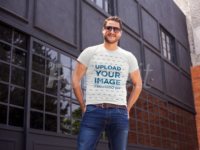Young Happy Guy Wearing a Round Neck Tee Template While Outside a Closed Bar