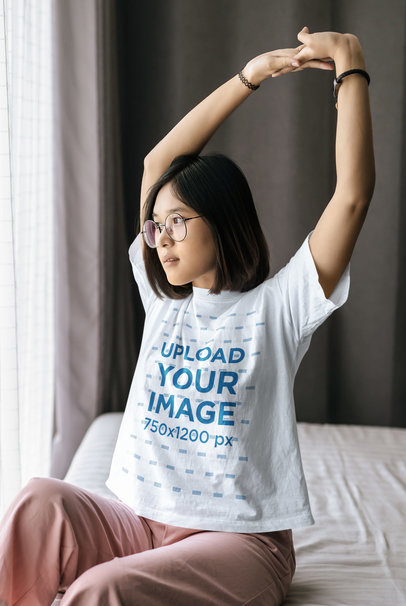 T-Shirt Mockup of a Woman Stretching Her Arms in the Morning