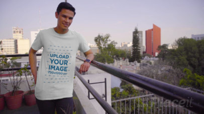 T-Shirt Mockup of a Man Posing at a Balcony 