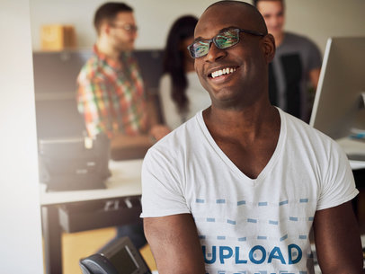V-Neck T-Shirt Mockup of a Happy Man in a Coworking Space