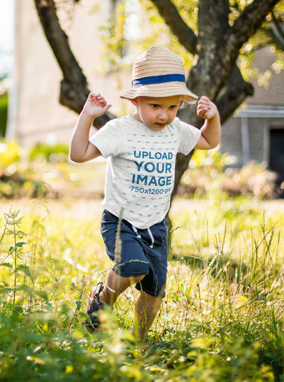 Heathered T-Shirt Mockup of a Baby Boy Walking in a Garden