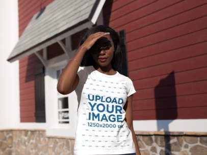 Mockup of a Young Woman Wearing a Round Neck Tee While Walking on a Sunny Day 16052