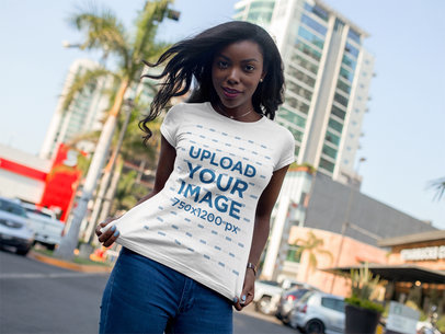 Mockup of a Young Woman Wearing a Round Neck Tee While at the City
