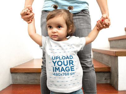 Mockup of a Baby Girl Going Wearing a T-Shirt Walking With The Help of Her Mom
