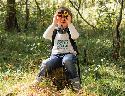 Sweatshirt Mockup of a Boy Using Binoculars in the Forest