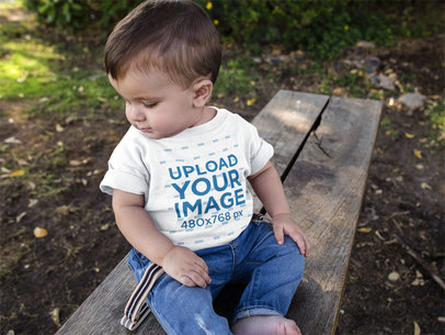 Mockup of a Baby Boy Looking Down to the Floor While Wearing a Tshirt