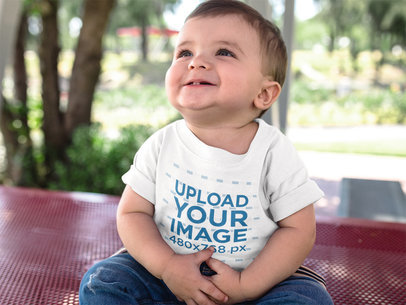 Baby Boy Looking up While Smiling Wearing a Round Neck T-Shirt Mockup