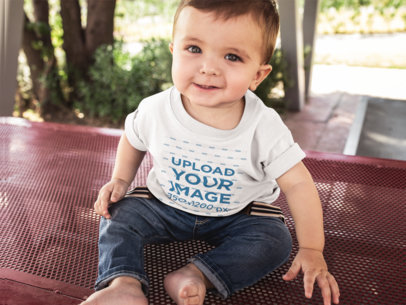 Little Baby Boy Looking to the Camera Wearing a T-Shirt Template While Sitting Down