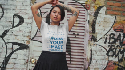 T-Shirt Video Featuring a Tattooed Woman Posing Against a Graffiti Wall 