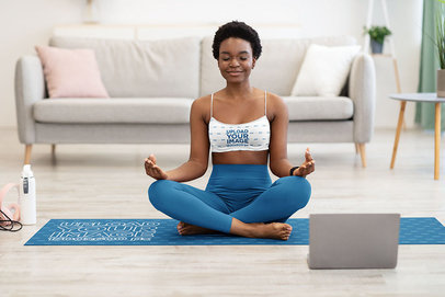 Sports Bra Mockup of a Short-Haired Yogi Meditating on a Yoga Mat