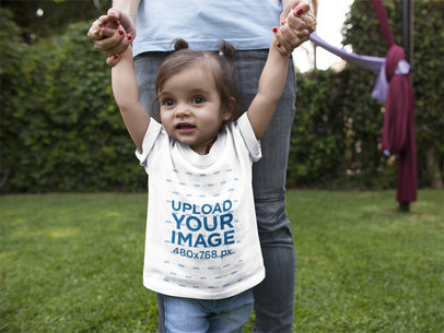 Baby Girl Walking with her Mom While Wearing a T-Shirt Mockup at Her Garden
