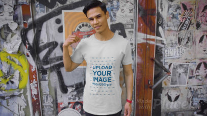 T-Shirt Video Featuring a Man Posing Against a Graffiti Wall