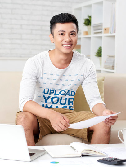 Heathered Long Sleeve Tee Mockup of a Man Working at His Living Room  46902-r-el2