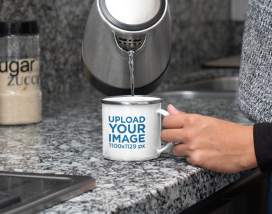 Mockup of a Woman Pouring Water into a 12 oz Enamel Mug