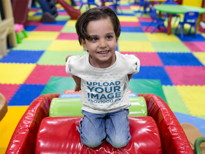 Little Kid Wearing a Round Neck Tee Mockup While at a Playground