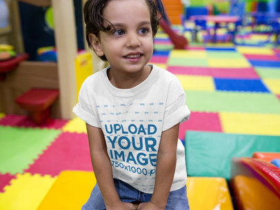 Little Kid Wearing a Round Neck T-Shirt Mockup While at a Playground