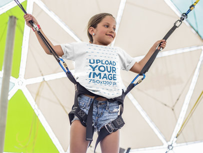 Mockup of a White Kid Wearing a T-Shirt While About to Jump in an Amusement Park