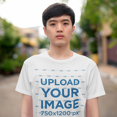 Round-Neck Tee Mockup Featuring a Teenager Boy Posing in the Street