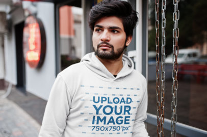 Hoodie Mockup of a Bearded Young Man Walking Down the Street