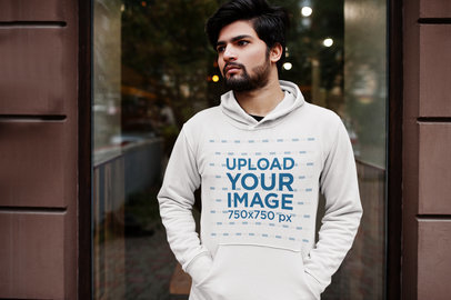 Hoodie Mockup Featuring a Serious Bearded Man Posing in the Street