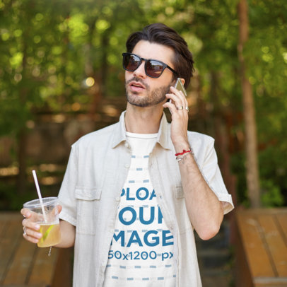 T-Shirt Mockup of a Man Holding a Lemonade and Talking on the Phone