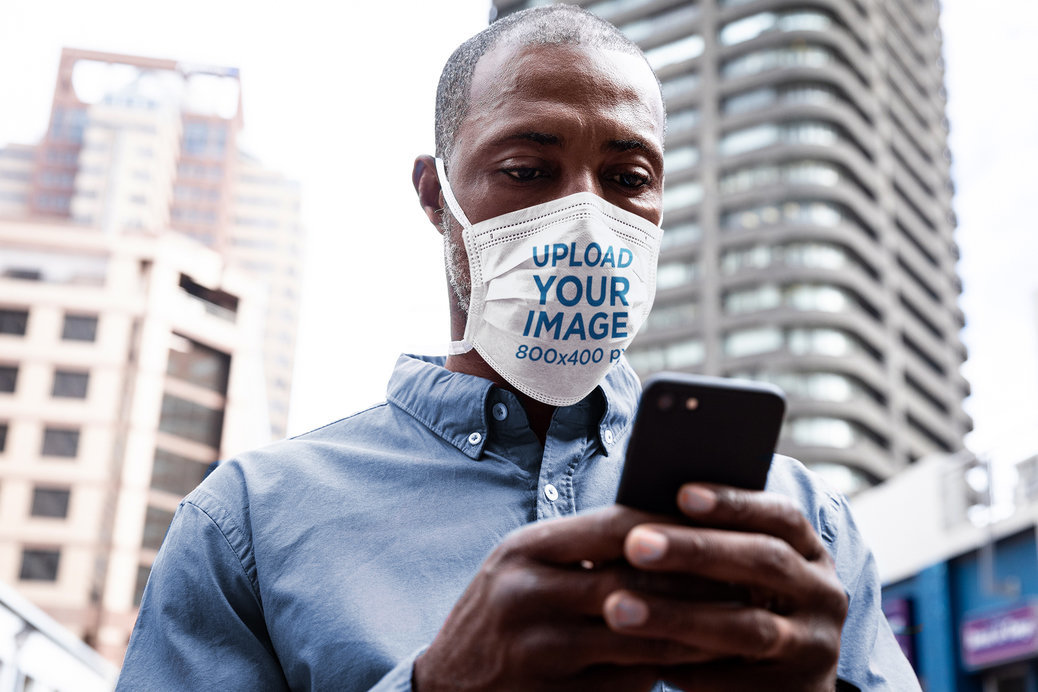 Face Mask Mockup Featuring a Serious Man Reading a Text Message