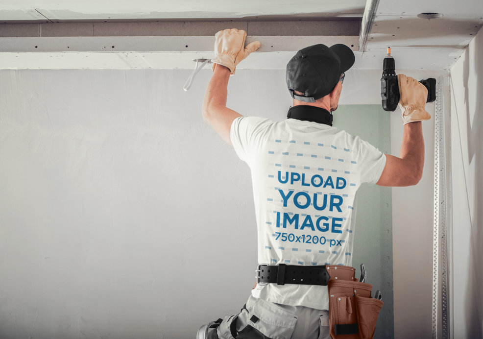 Back-View T-Shirt Mockup of a Contractor Working with a Drill