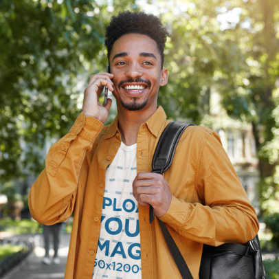 T-Shirt Mockup of a Smiling Man Talking on the Phone 