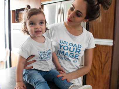 Young Mom with her Baby Girl in the Kitchen Wearing Different Round Neck T-Shirts Mockup