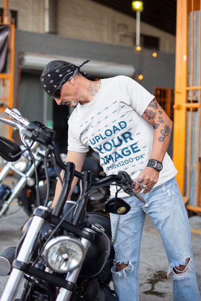 T-Shirt Mockup of a Middle-Aged Biker Fixing His Motorcycle's Seat 20245a
