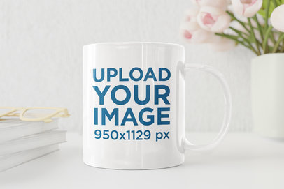 Mockup of an 11 oz Coffee Mug by a Pot with Pink Flowers
