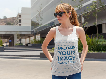 Pretty Woman Wearing a Bella Canvas Tank Top Mockup While in the City